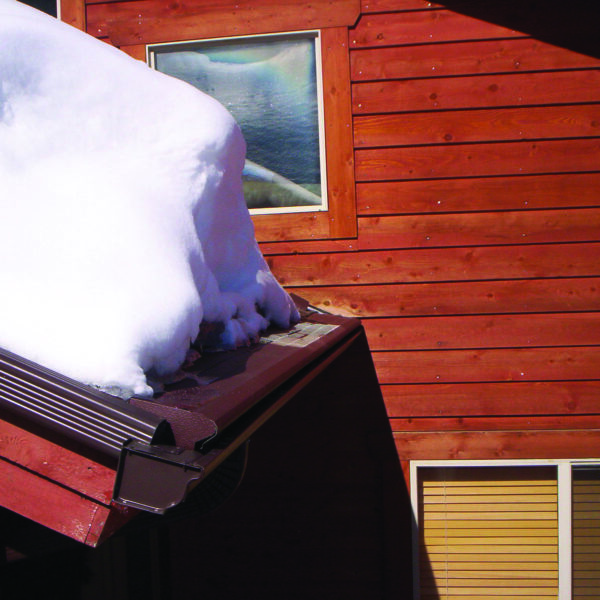 Helmet Heat protects gutters from snow. Snow on top of gutters on a house in SE Michigan