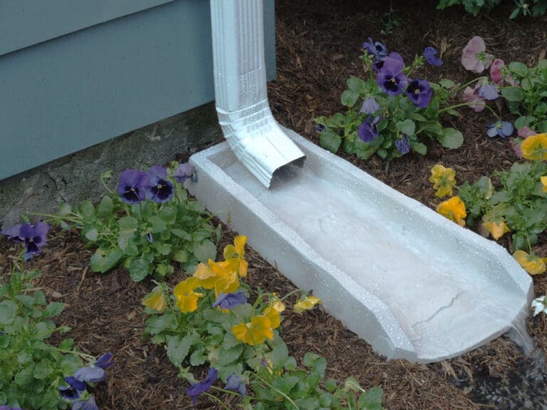 White gutter downspouts with proper water management