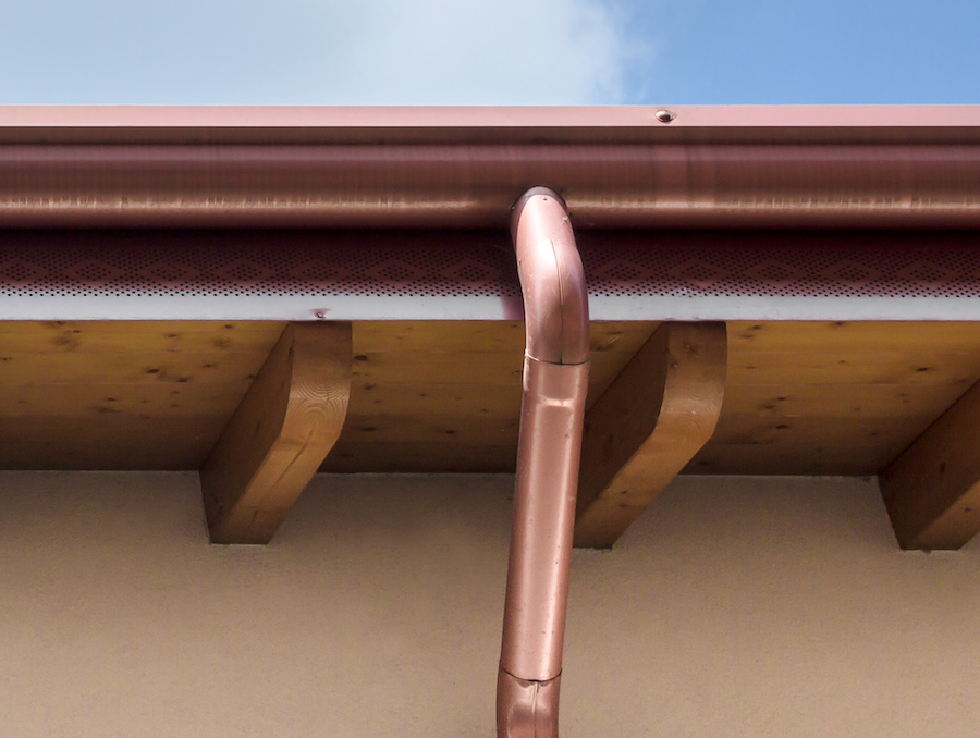 Copper gutters and copper downspout.