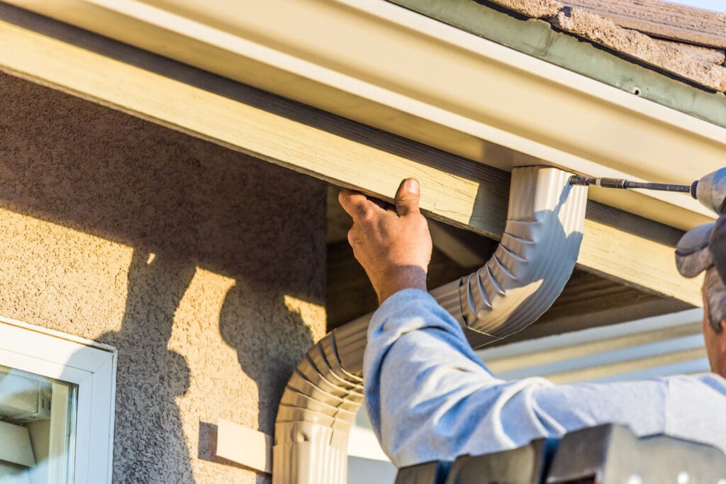 Technician replacing gutters